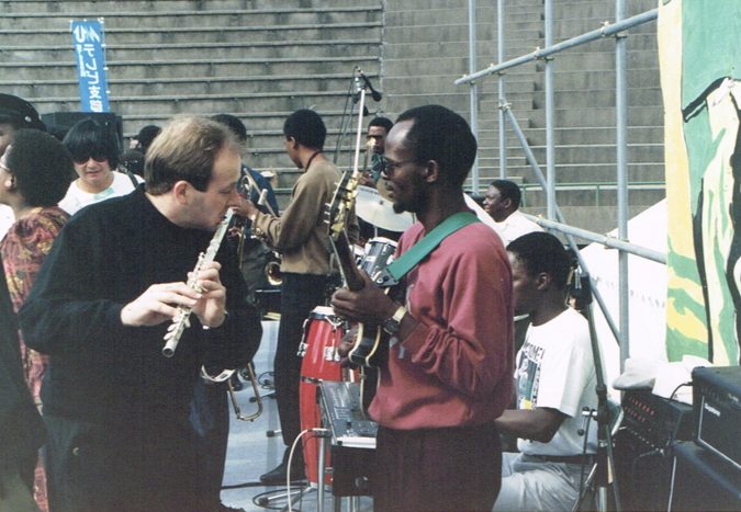 _ South African musical band members of the Amandla cultural troupe on stage during sound check and rehearsal, as preparations for the rally frantically go on around them.  _ South African musical band members of the Amandla cultural troupe on stage during sound check and rehearsal, as preparations for the rally frantically go on around them.