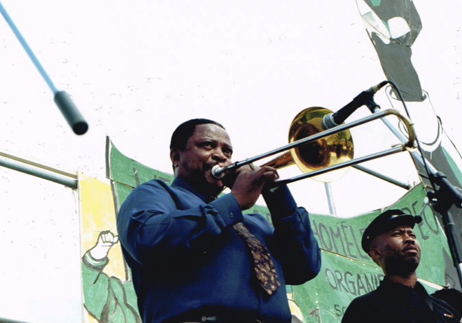 _ Jazz musician Jonas Gwangwa (center), director of the Amandla troupe, during rehearsal. Like the other performers, Gwangwa was living in exile from his native South Africa.  _ Jazz musician Jonas Gwangwa (center), director of the Amandla troupe, during rehearsal. Like the other performers, Gwangwa was living in exile from his native South Africa.