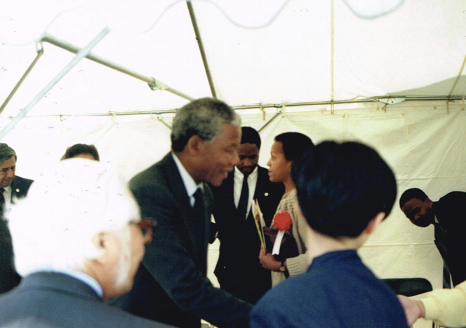 _ Guest of honor: Nelson Mandela, deputy president of the African National Congress, arrives with a 14-member ANC delegation, making his way into the VIP tent at poolside.  _ Guest of honor: Nelson Mandela, deputy president of the African National Congress, arrives with a 14-member ANC delegation, making his way into the VIP tent at poolside.