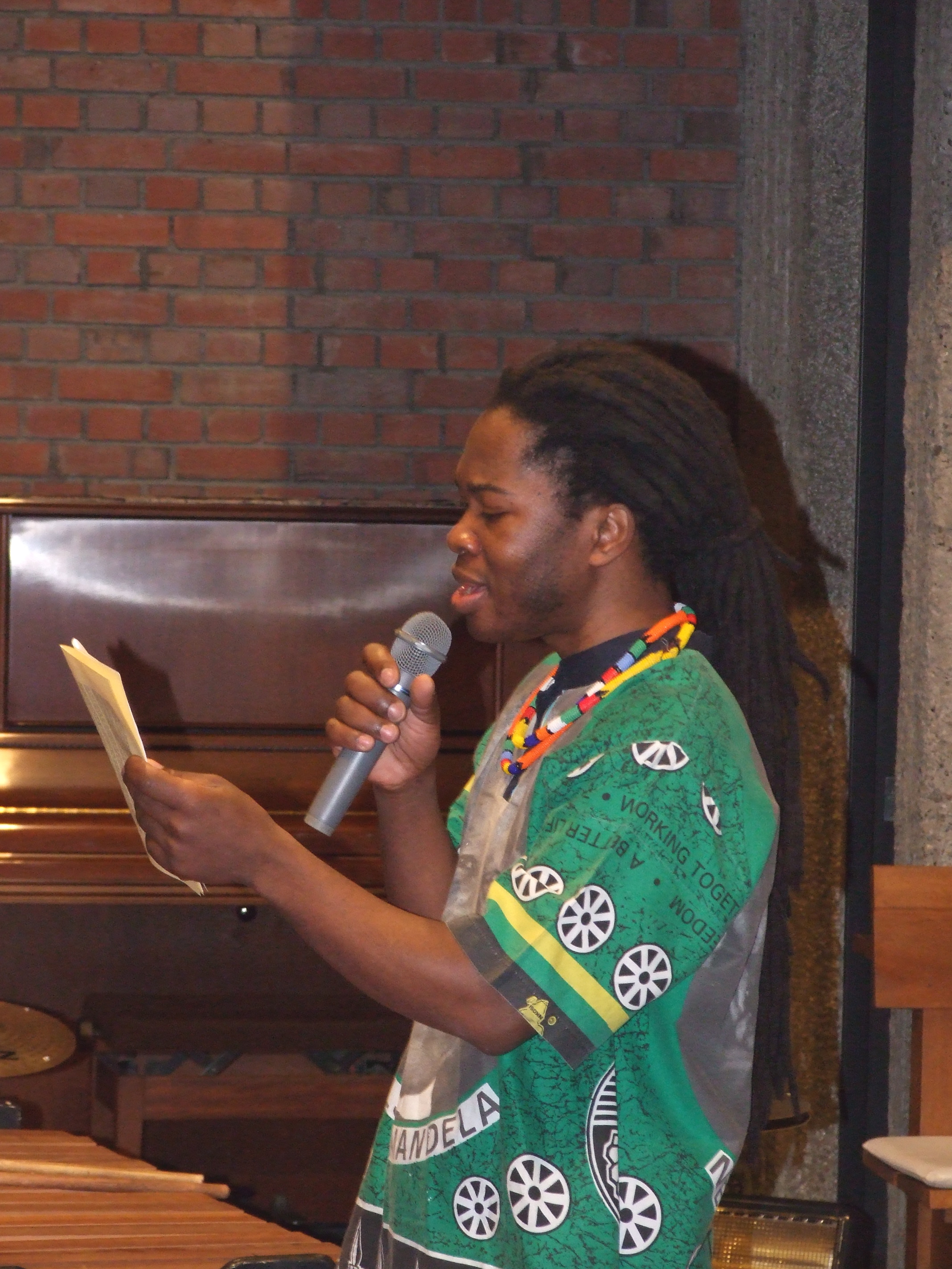 _ Nkosi leads the audience in singing the South African national anthem, which includes the former liberation song  _ Nkosi leads the audience in singing the South African national anthem, which includes the former liberation song