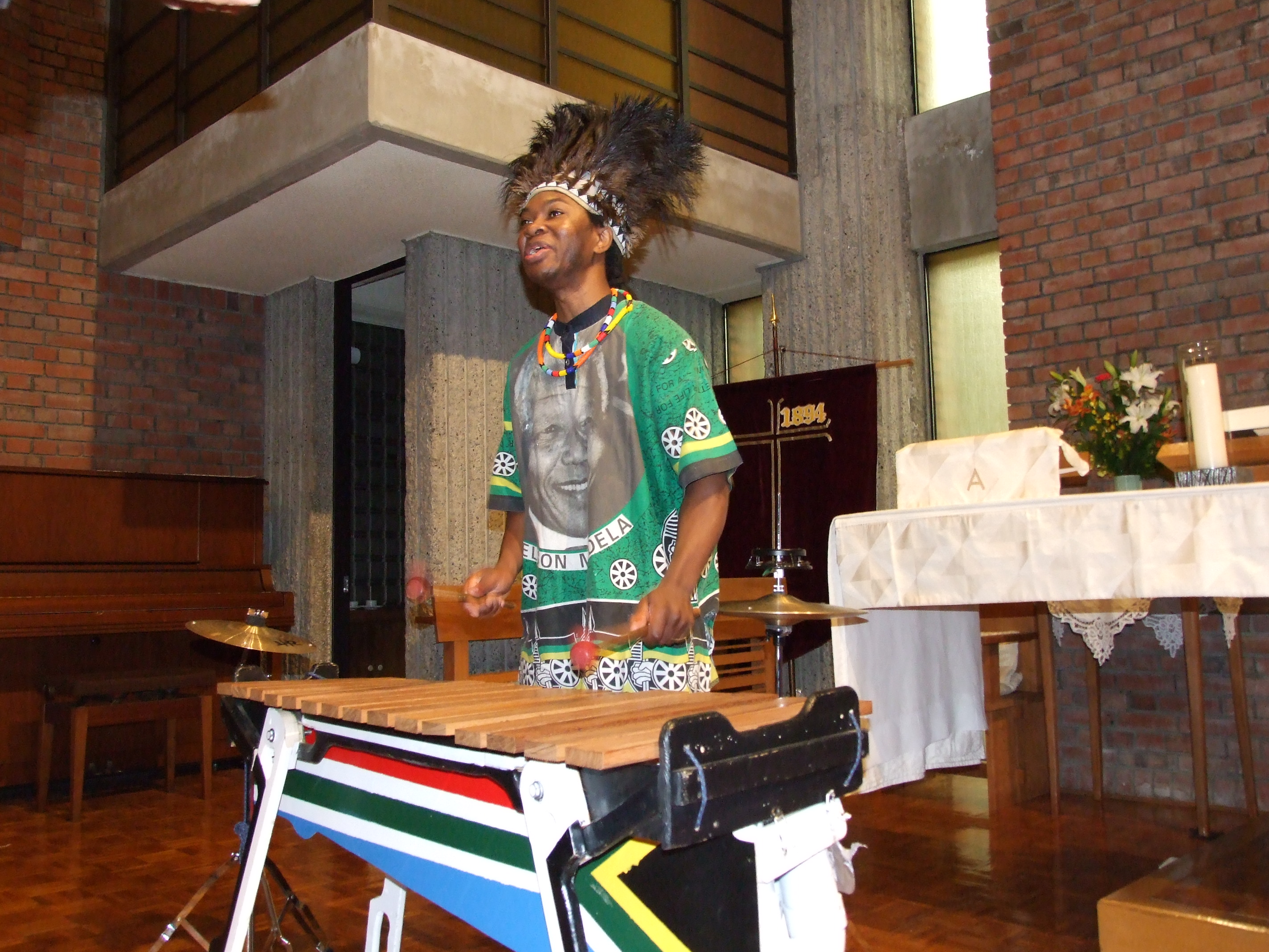 _ For the grand finale, Nkosi and his partner chant and jam on marimbas, bringing all the church audience members to their feet.  _ For the grand finale, Nkosi and his partner chant and jam on marimbas, bringing all the church audience members to their feet.