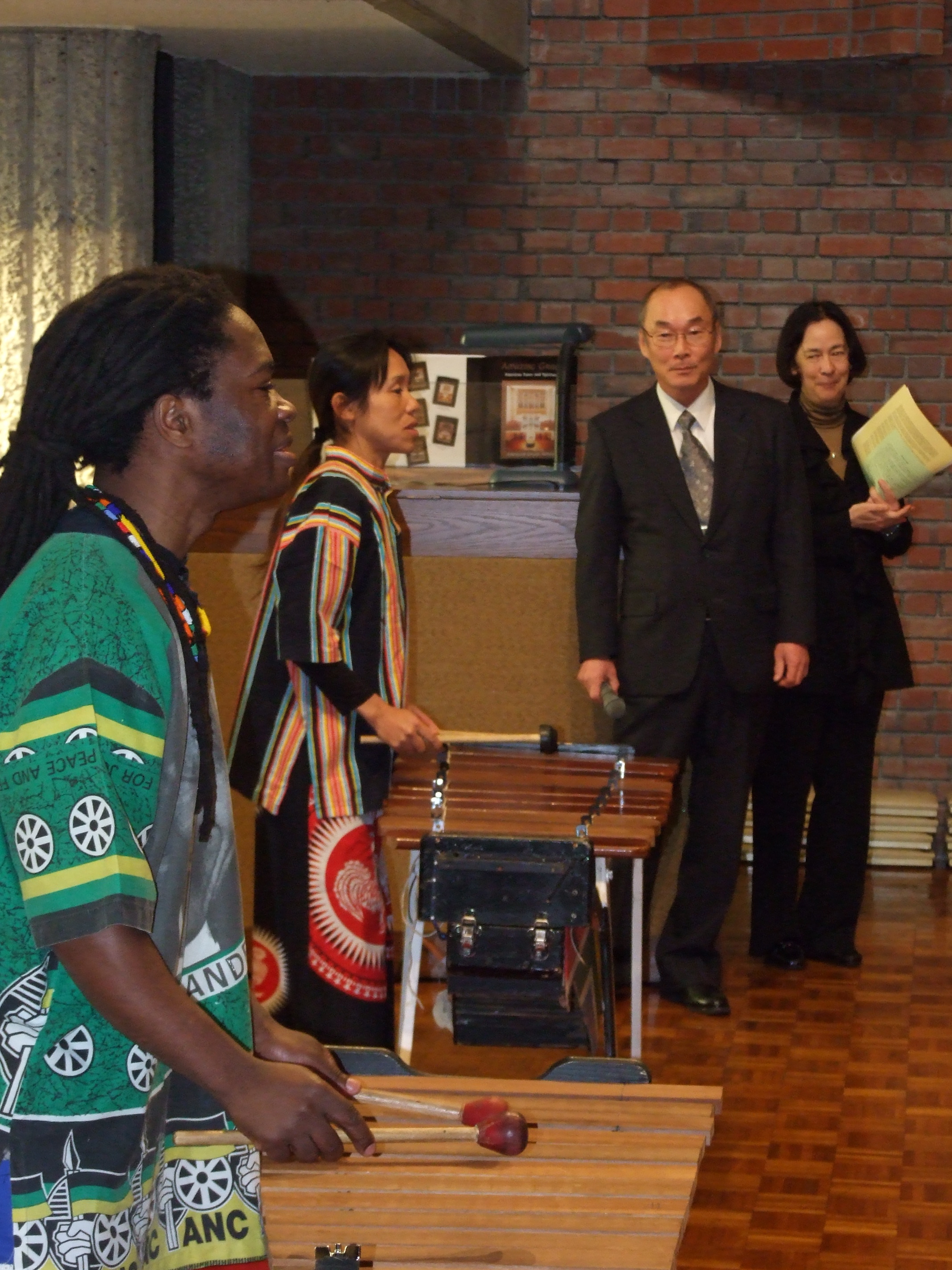 _ Joseph Nkosi (left), a South African living in Japan, and partner Tomomi Kawabe perform on marimbas as event organizers look on.  _ Joseph Nkosi (left), a South African living in Japan, and partner Tomomi Kawabe perform on marimbas as event organizers look on.